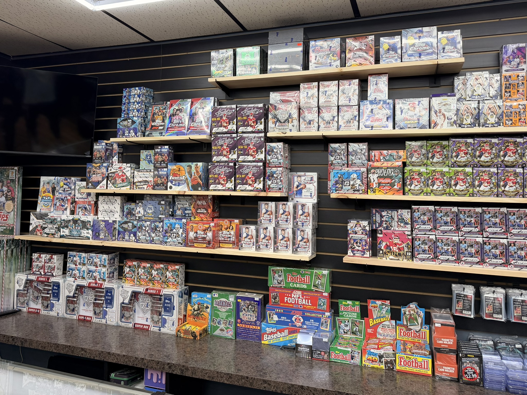 Sports cards wall — NFL NBA MLB hobby boxes at Alltimate DeLand FL