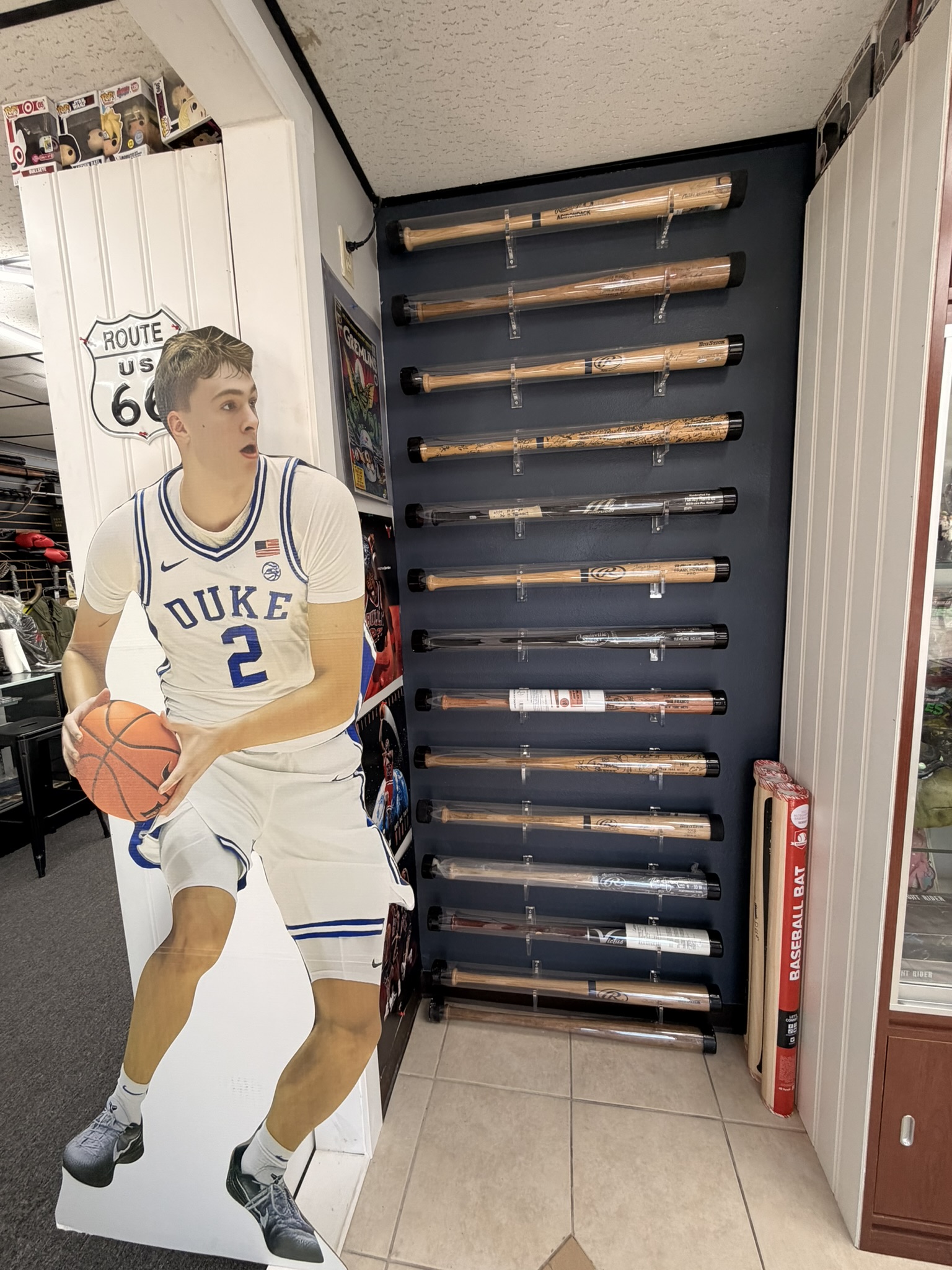 Autographed signed baseball bats wall display at Alltimate DeLand FL